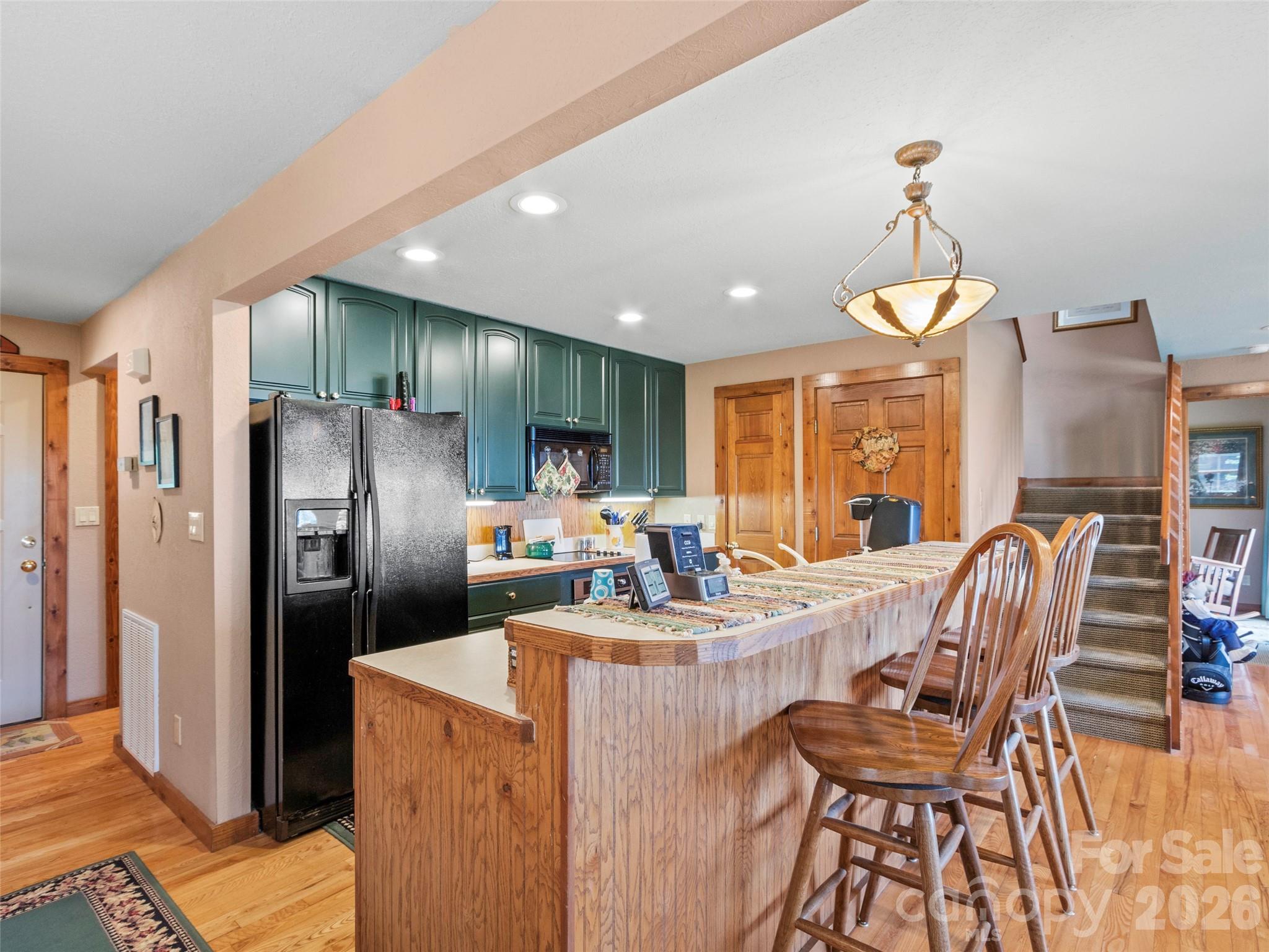 21 Ivy Ridge Road Burnsville, NC 28714 - Photo 9 of 35 a view of a dining room with furniture a chandelier and wooden floor