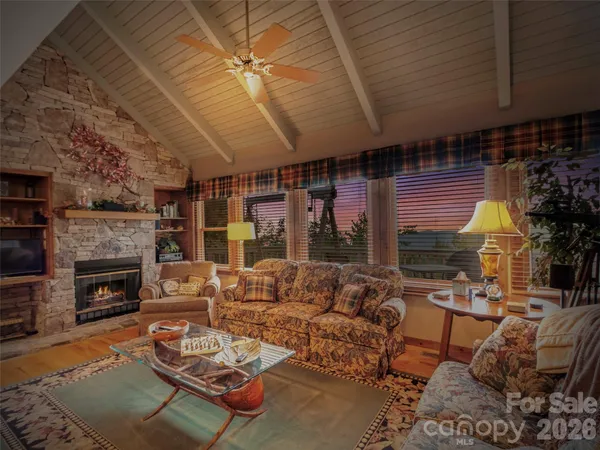 a living room with furniture a fireplace and a table