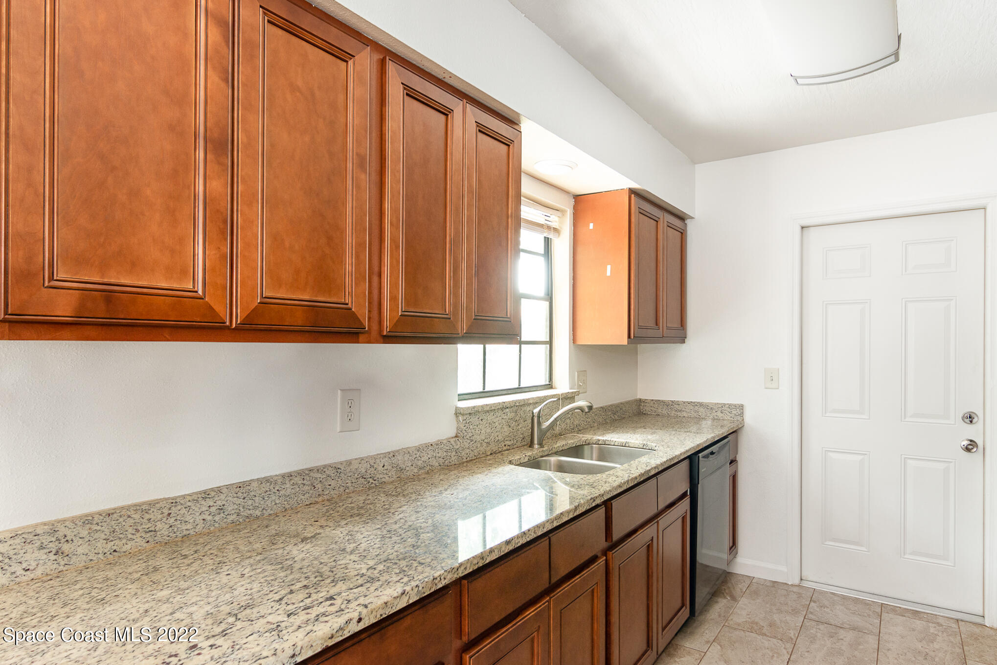 1456 Saxony Road Southwest Palm Bay, FL 32908 - Photo 3 of 22 a kitchen with granite countertop cabinets sink and window