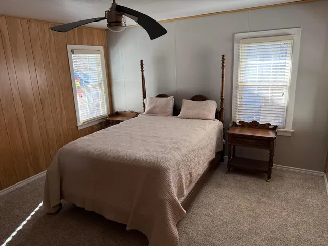 a bedroom with a bed and a window