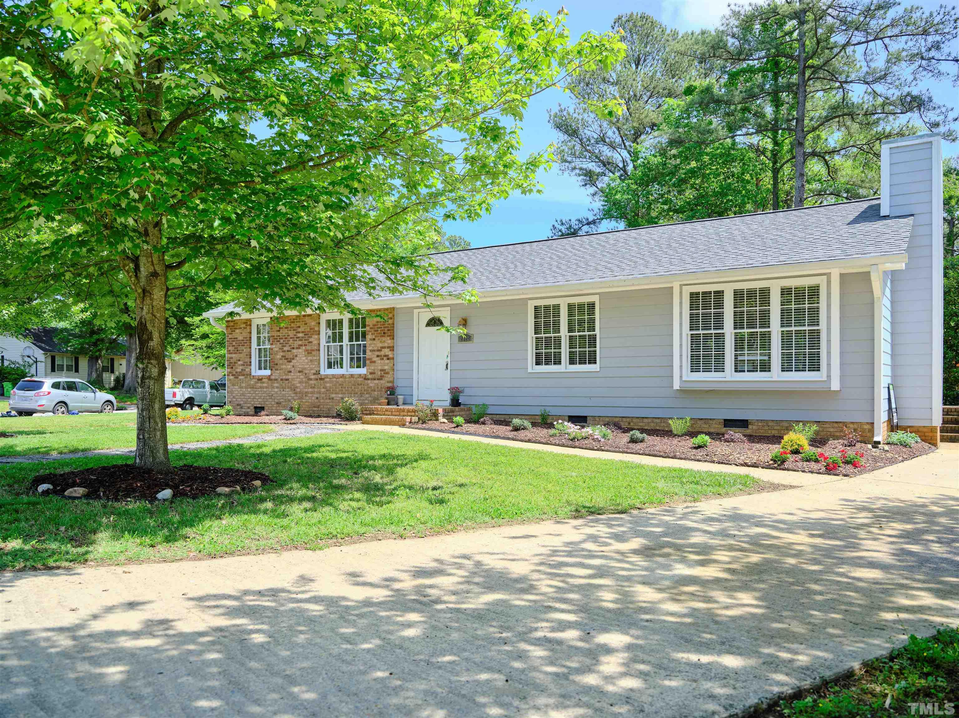2324 Ravenhill Drive Raleigh, NC 27615 - Photo 3 of 32 a front view of a house with a garden and trees