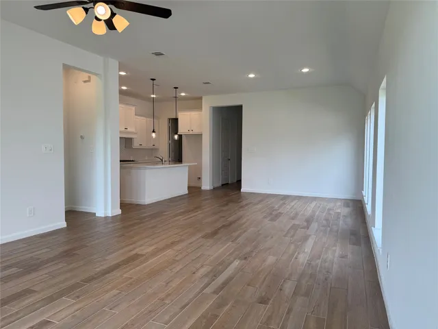 a view of a kitchen with wooden floor and a window