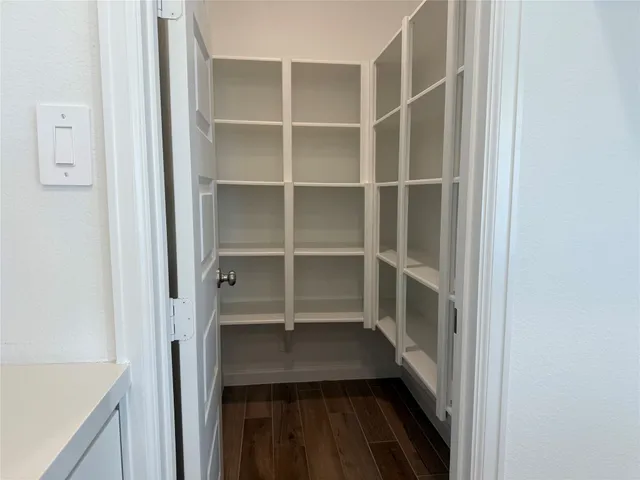 a view of walk in closet with empty racks