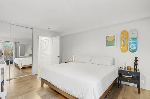 a bedroom with a bed and wooden floor