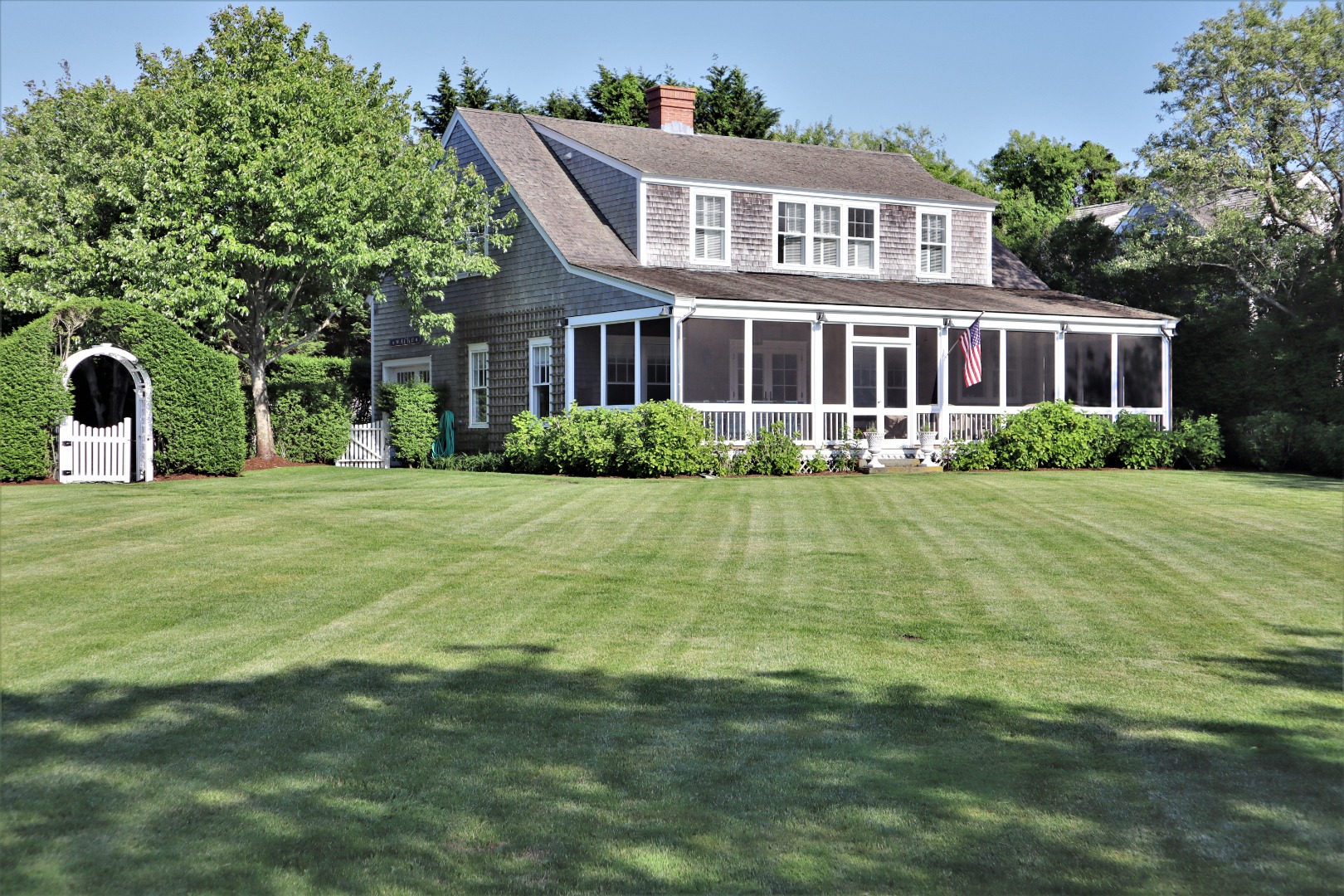 6 Ackermuck Road Nantucket, MA 02554 - Photo 2 of 40 a view of a house with a big yard and potted plants