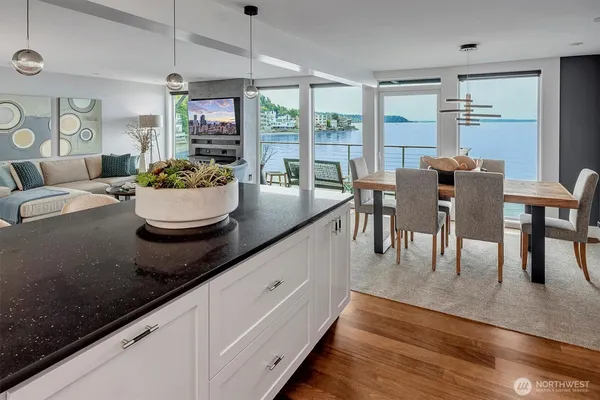 a kitchen with a dining table chairs and white walls