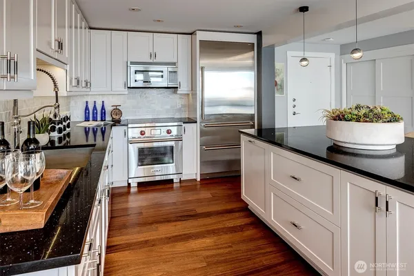 a kitchen with stainless steel appliances a stove refrigerator and a oven