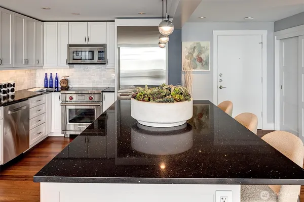 a kitchen with a sink a stove and cabinets