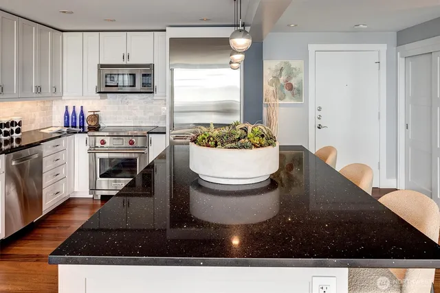 a kitchen with a sink a stove and cabinets