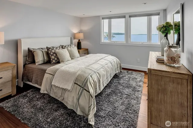 a bed sitting in a bedroom next to a window