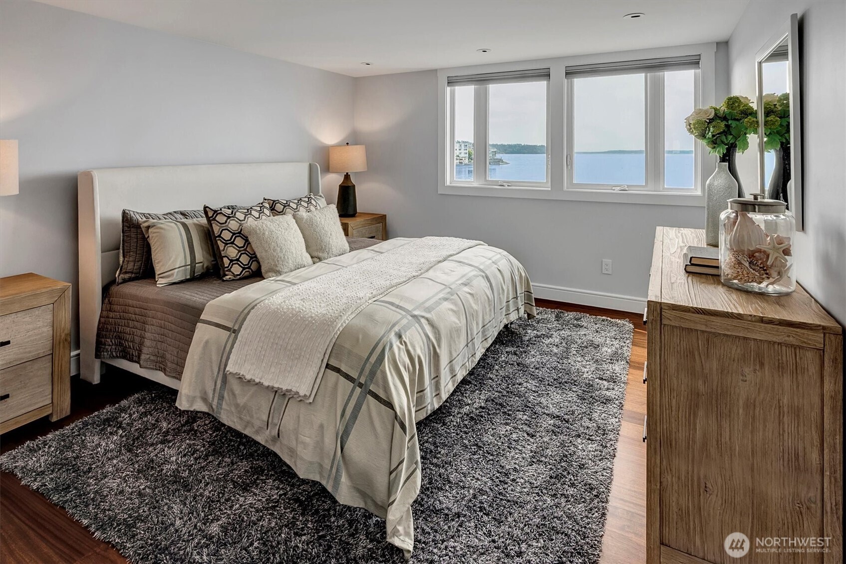 3717 Beach Drive Southwest, Unit 207 Seattle, WA 98116 - Photo 19 of 40 a bed sitting in a bedroom next to a window