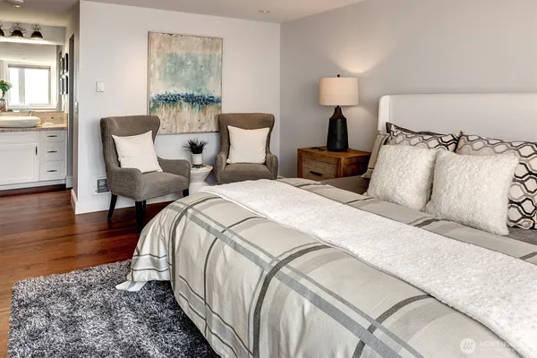 a bedroom with bed and wooden floor