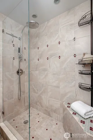 a bathroom with a toilet and a shower