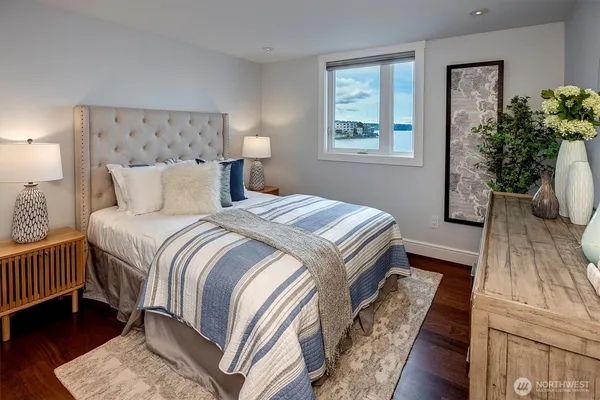 a bedroom with a large bed and a potted plant