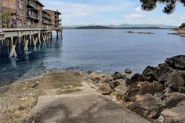 a view of a lake with lawn chairs
