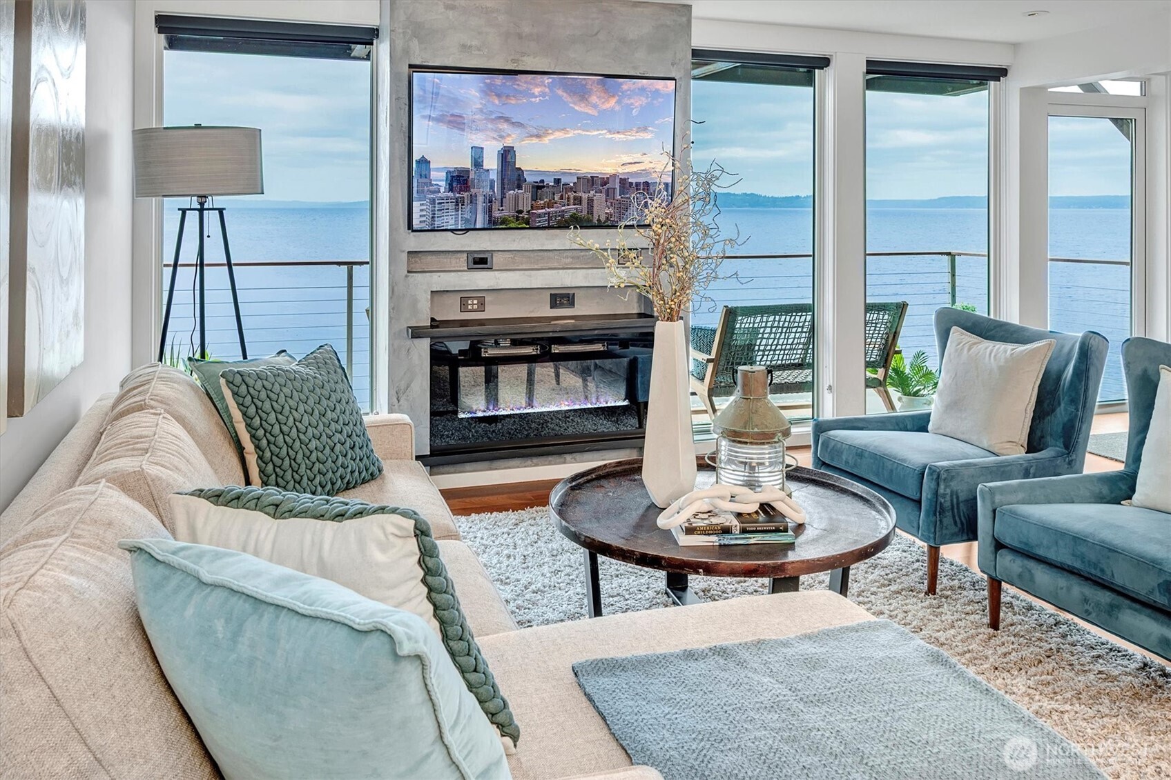 3717 Beach Drive Southwest, Unit 207 Seattle, WA 98116 - Photo 4 of 40 a living room with furniture a fireplace and a table