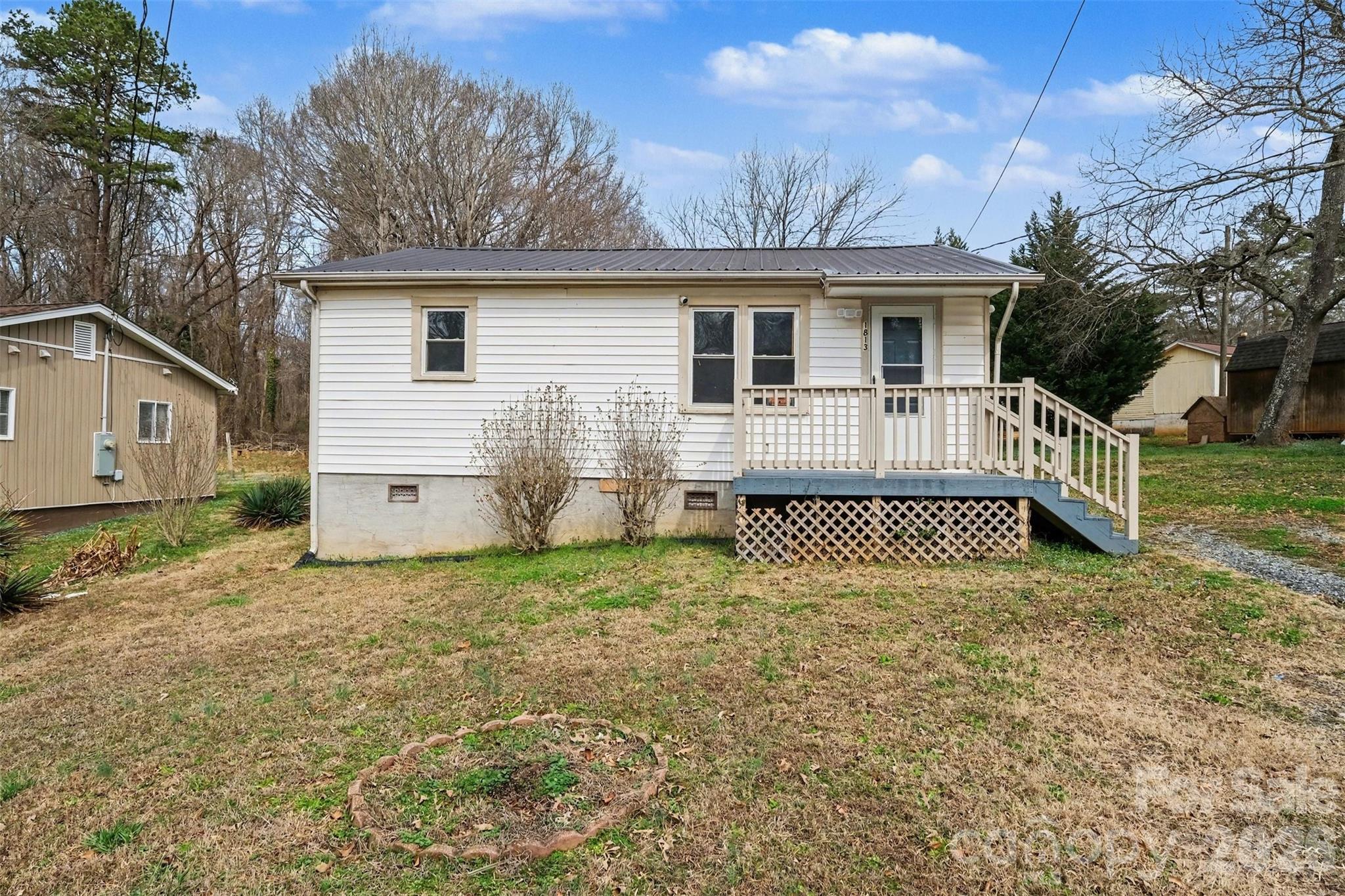 a view of a house with a yard and fence