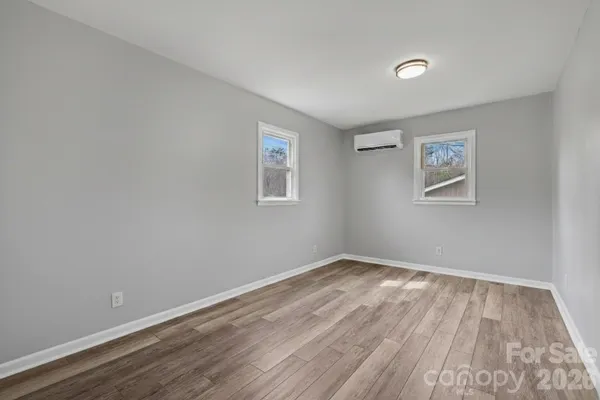 a view of room with wooden floor and window