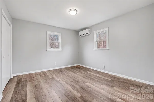 a view of room with window and hardwood floor