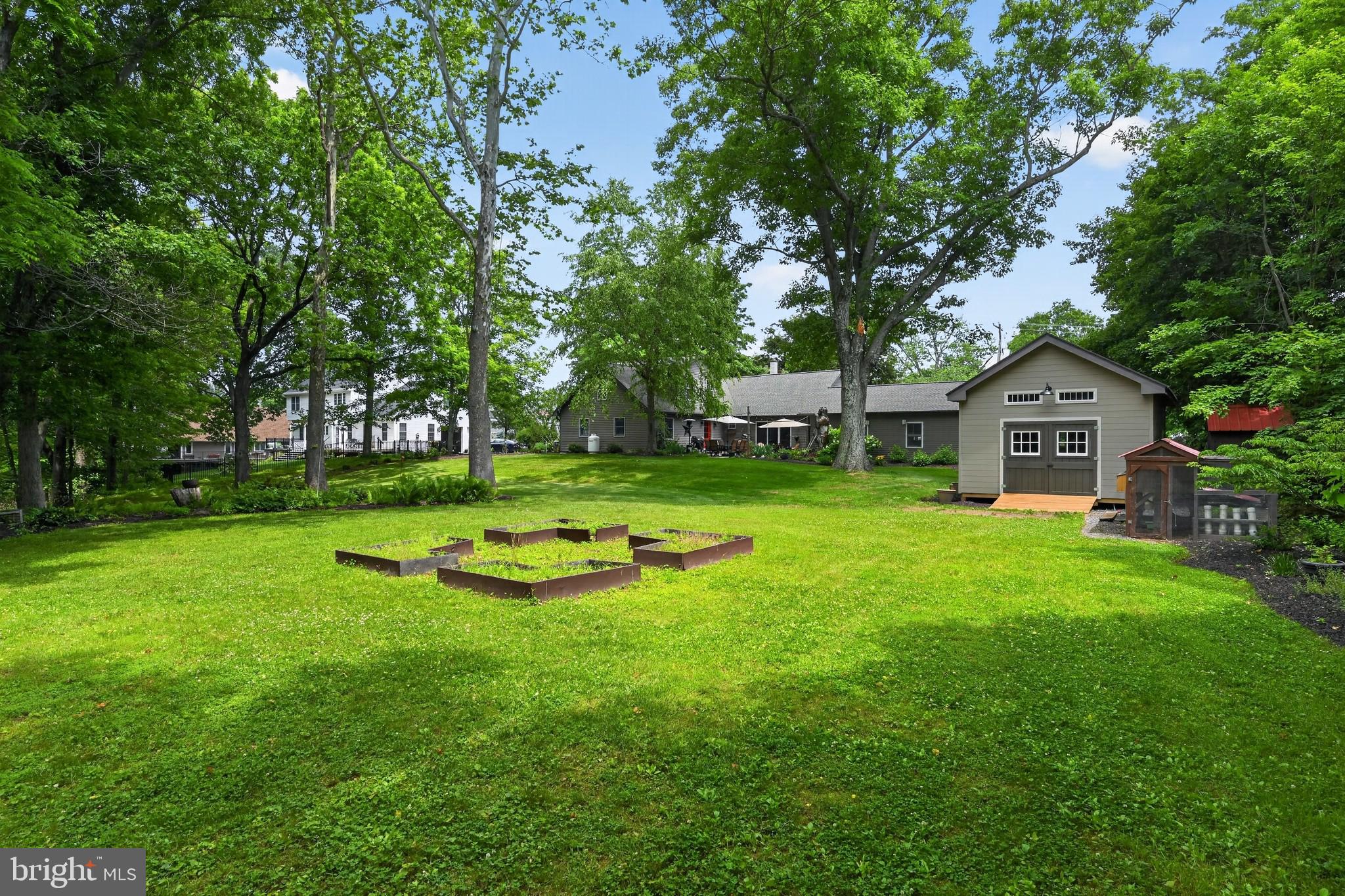 460 Wells Road Doylestown, PA 18901 - Photo 4 of 65 Serene backyard oasis with lush greenery.