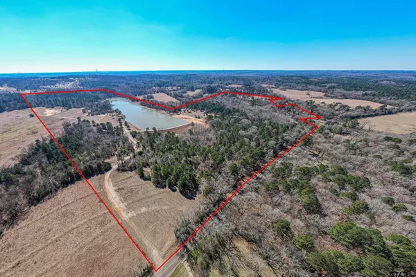 an aerial view of a houses with a yard