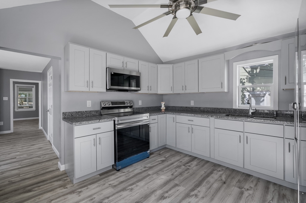55 Mendon Street Worcester, MA 01604 - Photo 11 of 29 a kitchen with granite countertop a stove sink and microwave