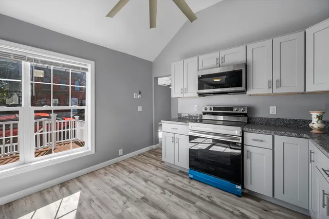 a kitchen with stainless steel appliances a stove microwave and sink