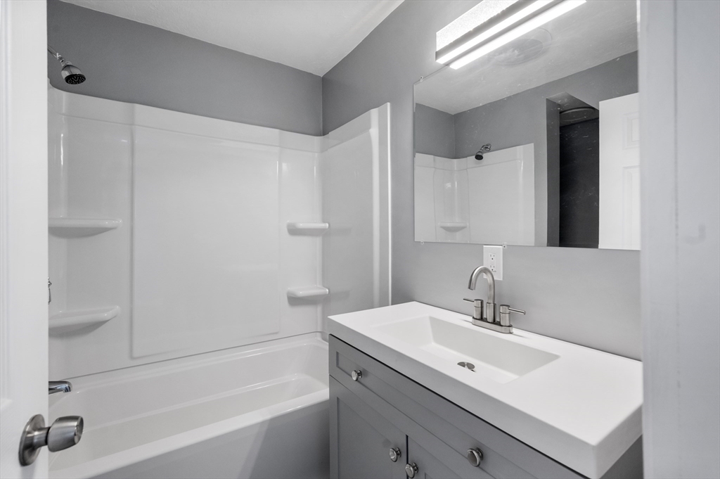 55 Mendon Street Worcester, MA 01604 - Photo 13 of 29 a bathroom with a sink toilet and shower