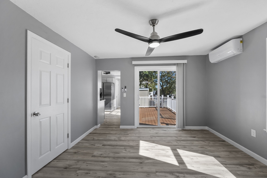 55 Mendon Street Worcester, MA 01604 - Photo 14 of 29 a view of a livingroom with wooden floor and a ceiling fan