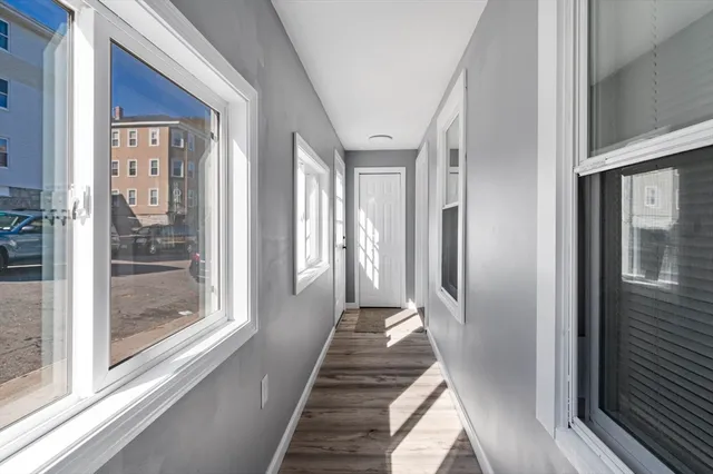 a view of a hallway with a glass door and outer view