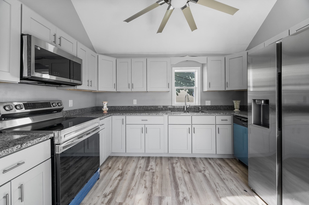 55 Mendon Street Worcester, MA 01604 - Photo 9 of 29 a kitchen with stainless steel appliances granite countertop a stove a sink and a microwave