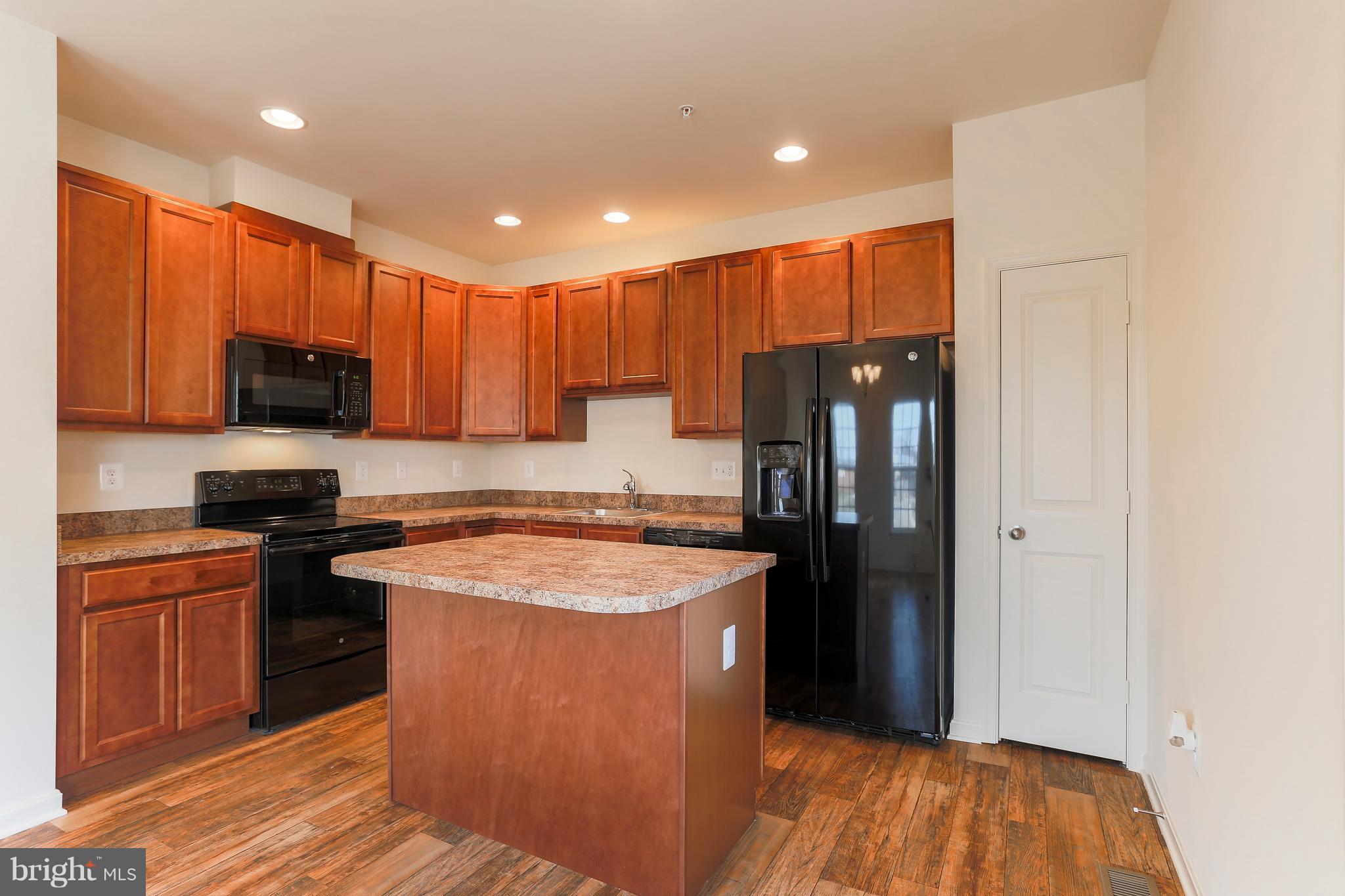 13 Back River Neck Road Baltimore, MD 21221 - Photo 27 of 30 a kitchen with stainless steel appliances granite countertop refrigerator a stove top oven a sink and dishwasher