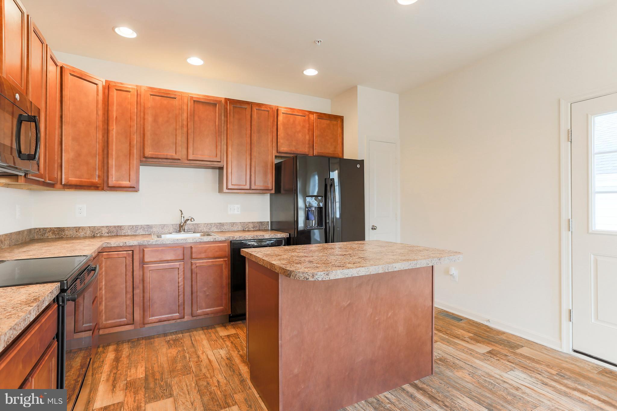 13 Back River Neck Road Baltimore, MD 21221 - Photo 28 of 30 a kitchen with stainless steel appliances granite countertop refrigerator sink and cabinets