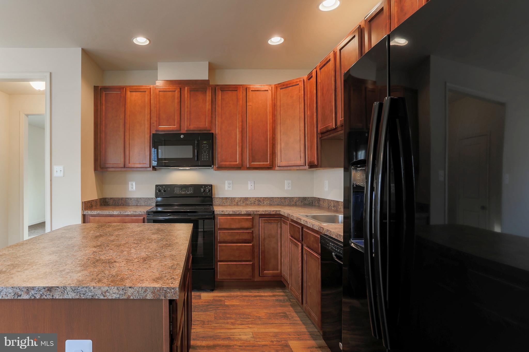 13 Back River Neck Road Baltimore, MD 21221 - Photo 30 of 30 a kitchen with stainless steel appliances granite countertop refrigerator stove microwave and sink