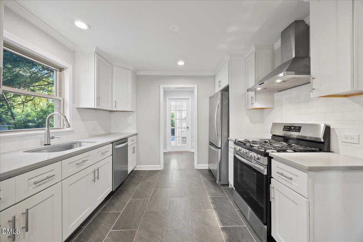 2915 Fawn Avenue Durham, NC 27705 - Photo 10 of 39 a kitchen with stainless steel appliances granite countertop a stove a sink dishwasher and a refrigerator
