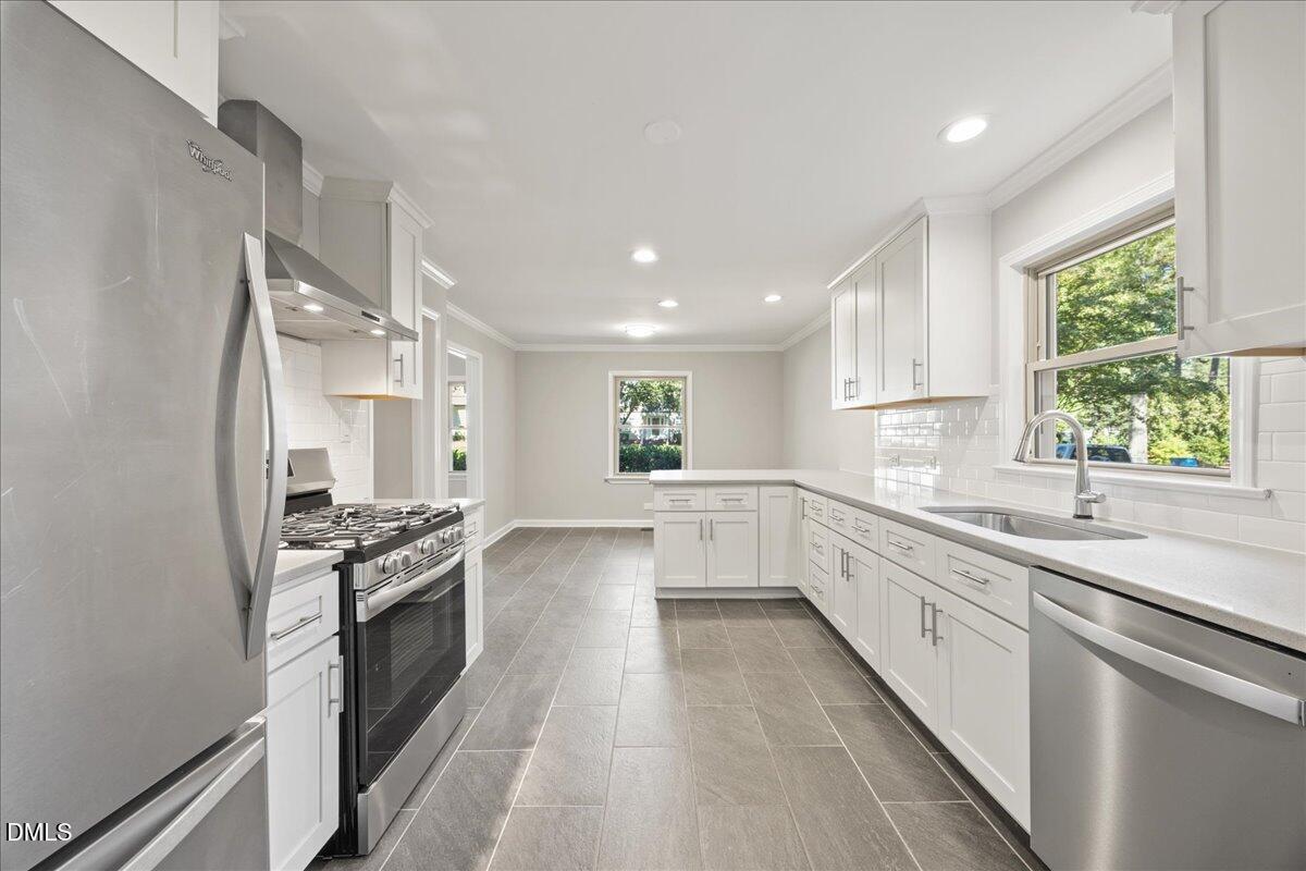 2915 Fawn Avenue Durham, NC 27705 - Photo 11 of 39 a kitchen with a sink stove top oven and cabinets