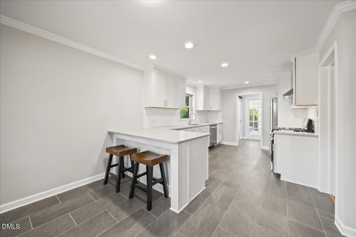2915 Fawn Avenue Durham, NC 27705 - Photo 12 of 39 a kitchen with a table and chairs in it