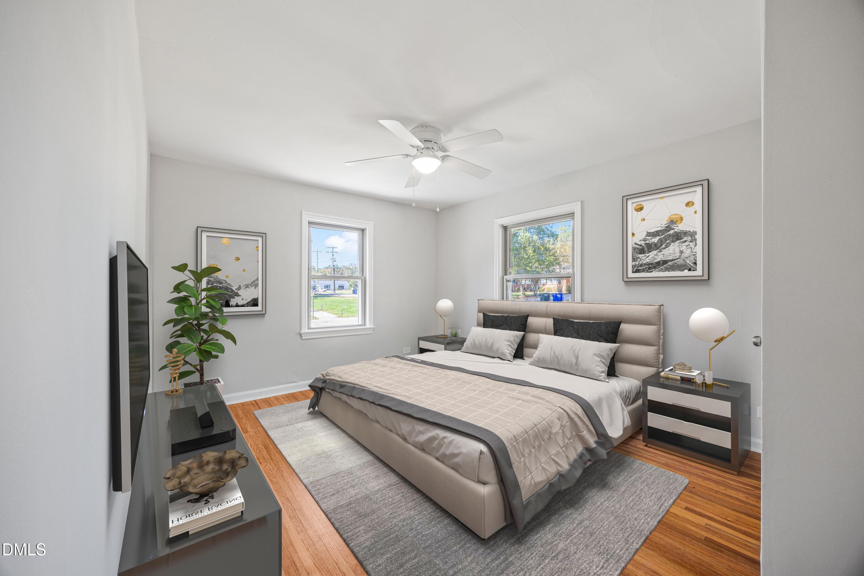 2915 Fawn Avenue Durham, NC 27705 - Photo 17 of 39 a bedroom with bed and a potted plant