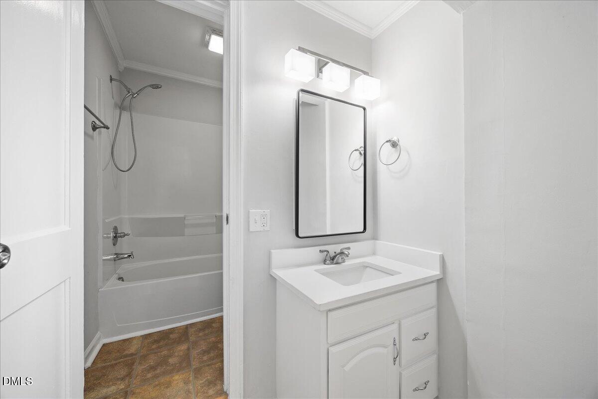 2915 Fawn Avenue Durham, NC 27705 - Photo 24 of 39 a bathroom with a sink mirror and shower