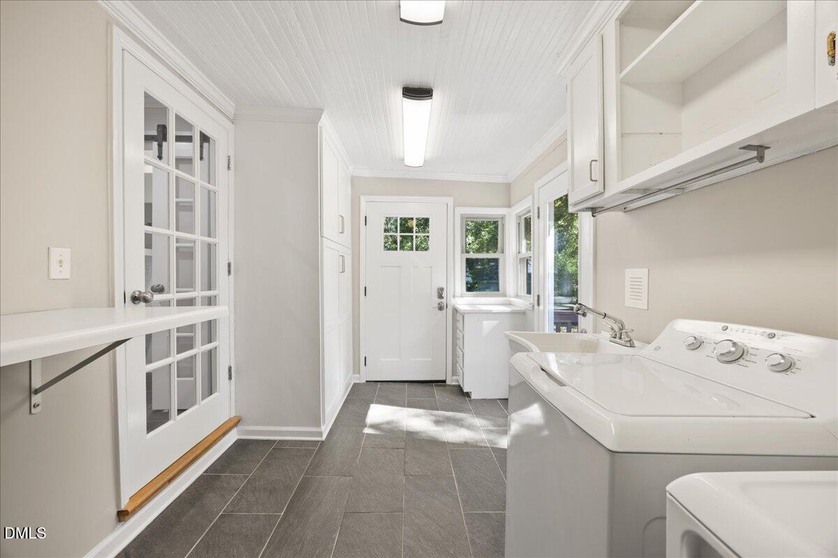 2915 Fawn Avenue Durham, NC 27705 - Photo 26 of 39 a utility room with cabinets washer and dryer