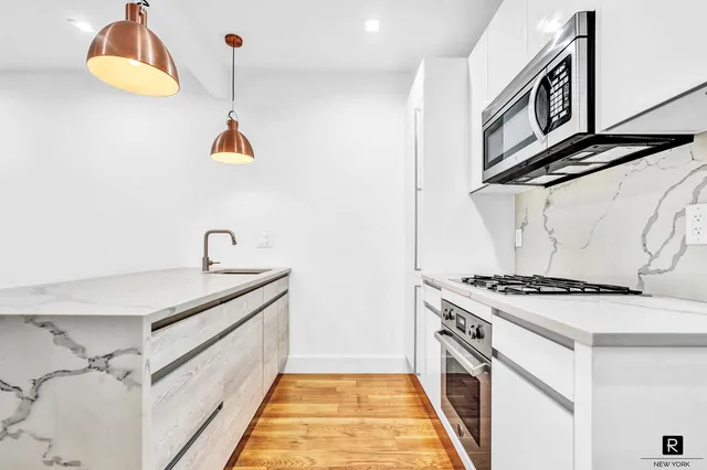 a kitchen with stainless steel appliances granite countertop a stove and a sink