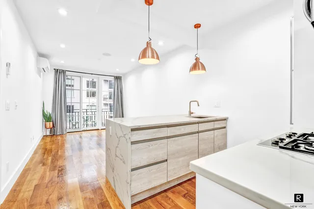 a kitchen with a sink a stove a dining table and chairs