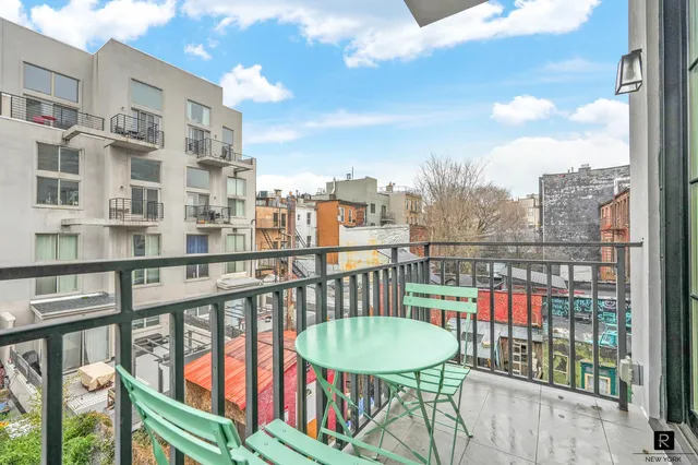 a view of a balcony with a chairs