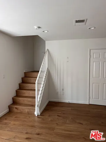 a view of entryway and hall with wooden floor