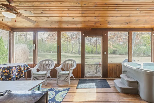 a living room with furniture and floor to ceiling windows