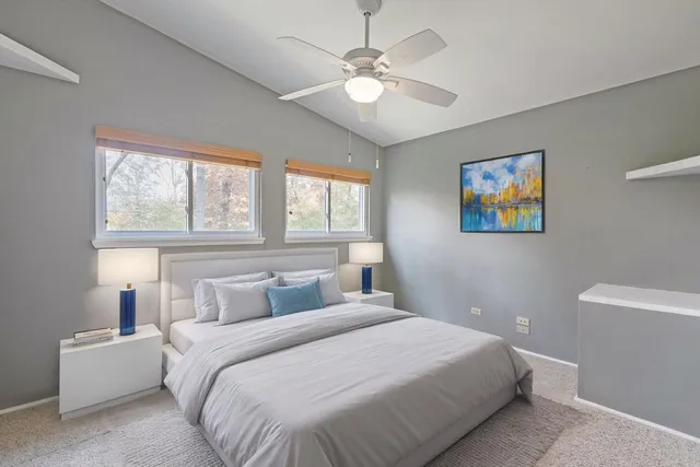a bedroom with a large bed and a chandelier