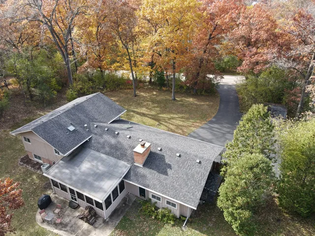 aerial view of a house with a yard