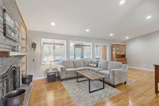 a living room with fireplace furniture and a rug