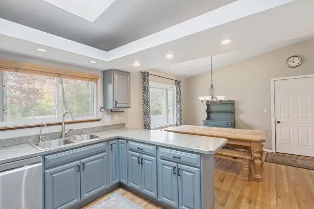 a kitchen with a sink window and cabinets
