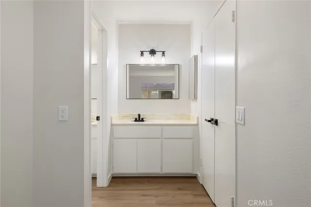 a bathroom with a sink and mirror with toilet